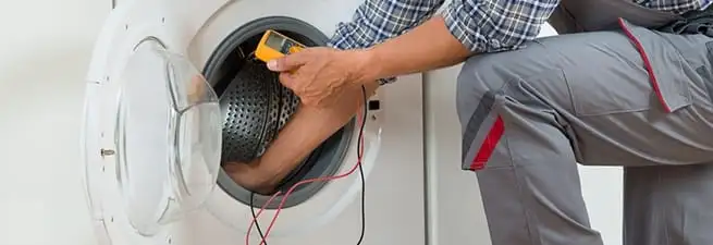 Dryer repair technician inspecting and repairing a clothes dryer in Green Bay, WI