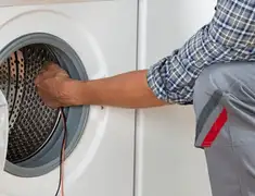 Dryer repair technician diagnosing and servicing a clothes dryer in Green Bay, WI