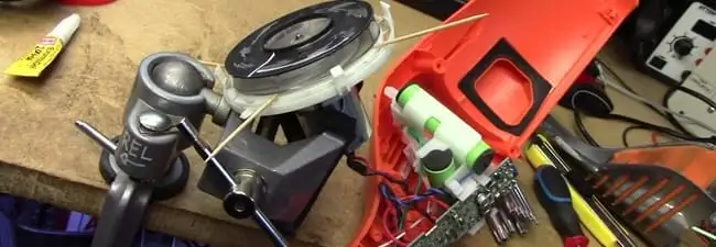 Vacuum cleaner repair parts and tools on a workbench in Green Bay, WI