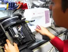 Vacuum repair technician servicing internal components on a workbench in Green Bay, WI