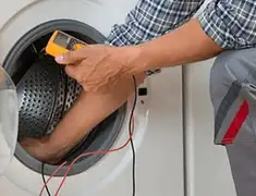 Washing machine repair technician testing a front-load washer with diagnostic tools in Green Bay, WI